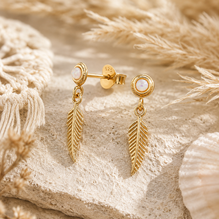 Gold earrings in feather design