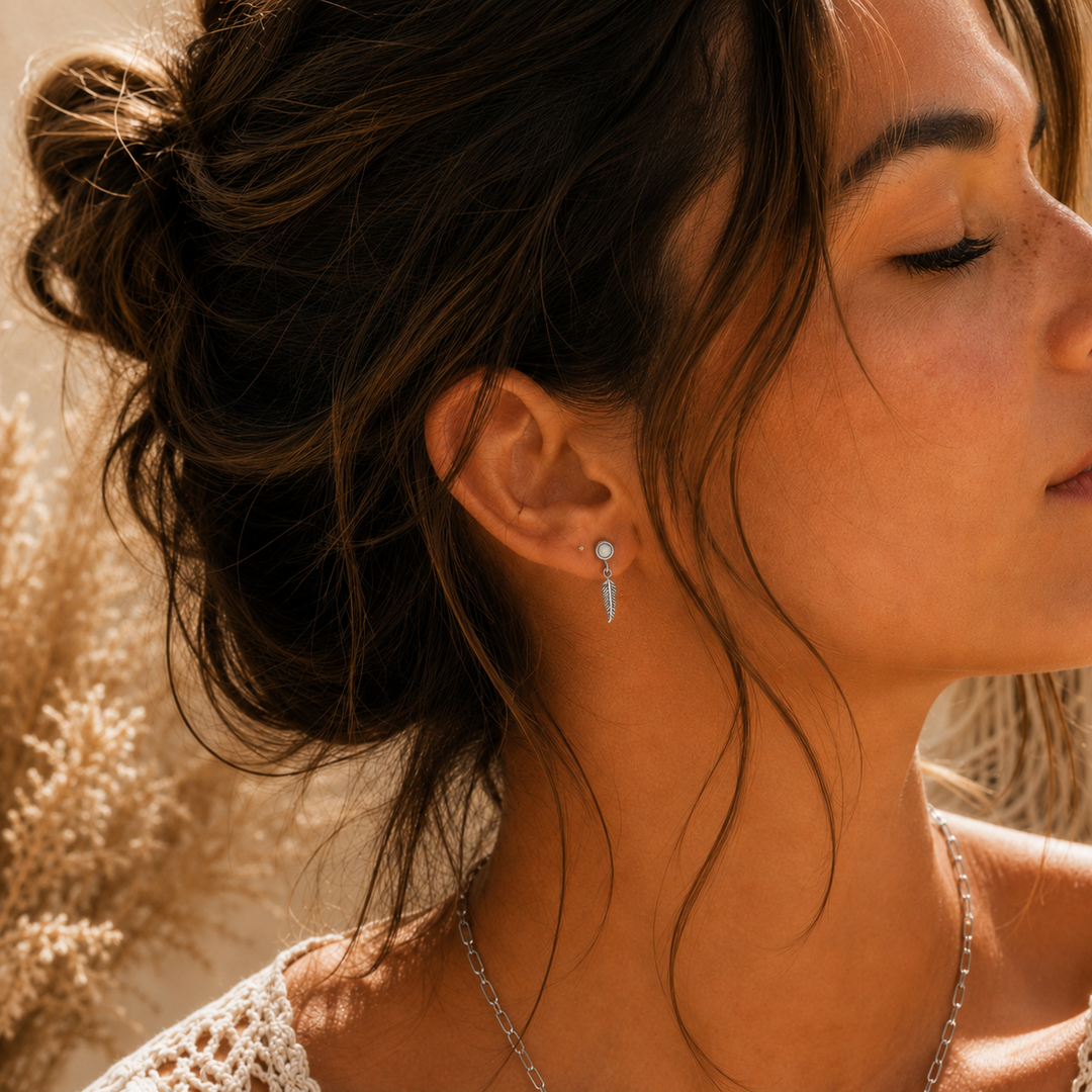 Bohemain woman wearing silver feather earrings 