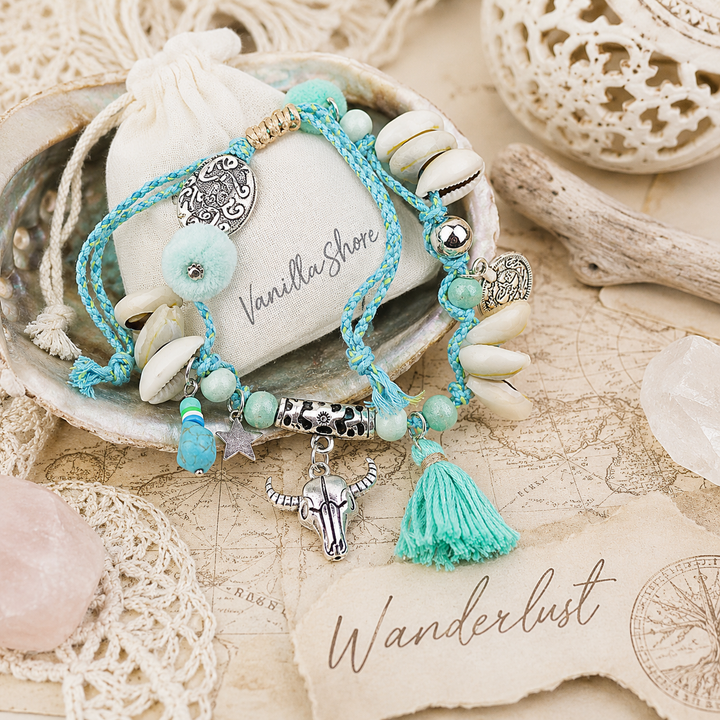 Turquoise beaded anklet with charms and tassels .