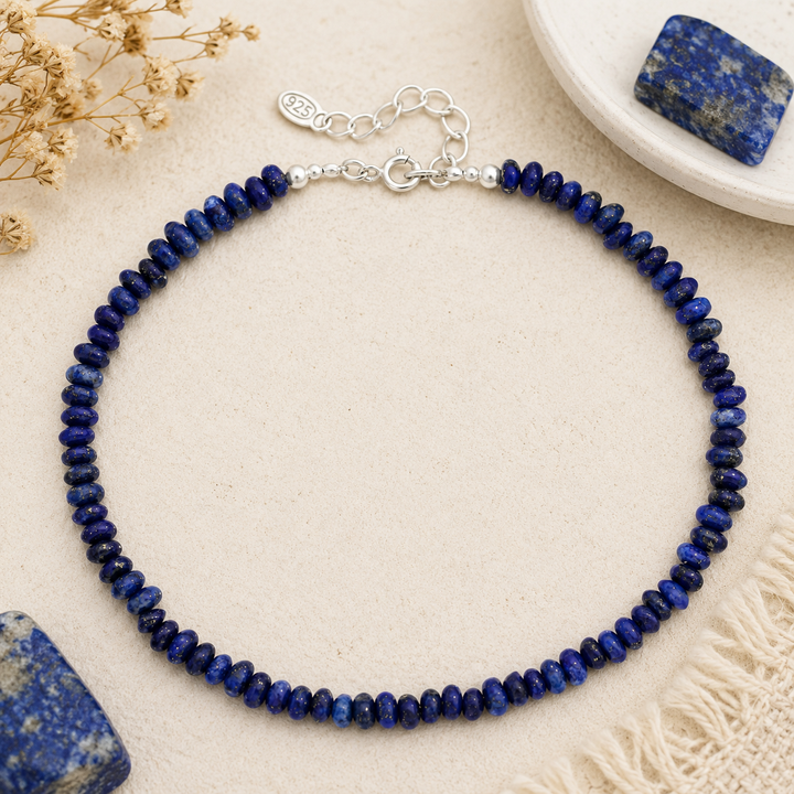 Blue beaded stone ankle on a beige surface with lapis stones 