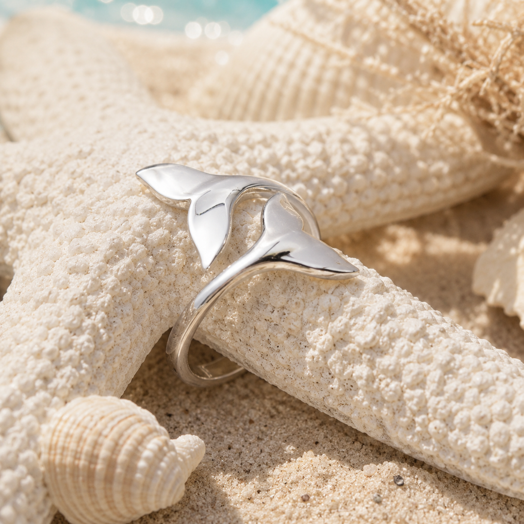 polished sterling silver whale tail ring in beach setting