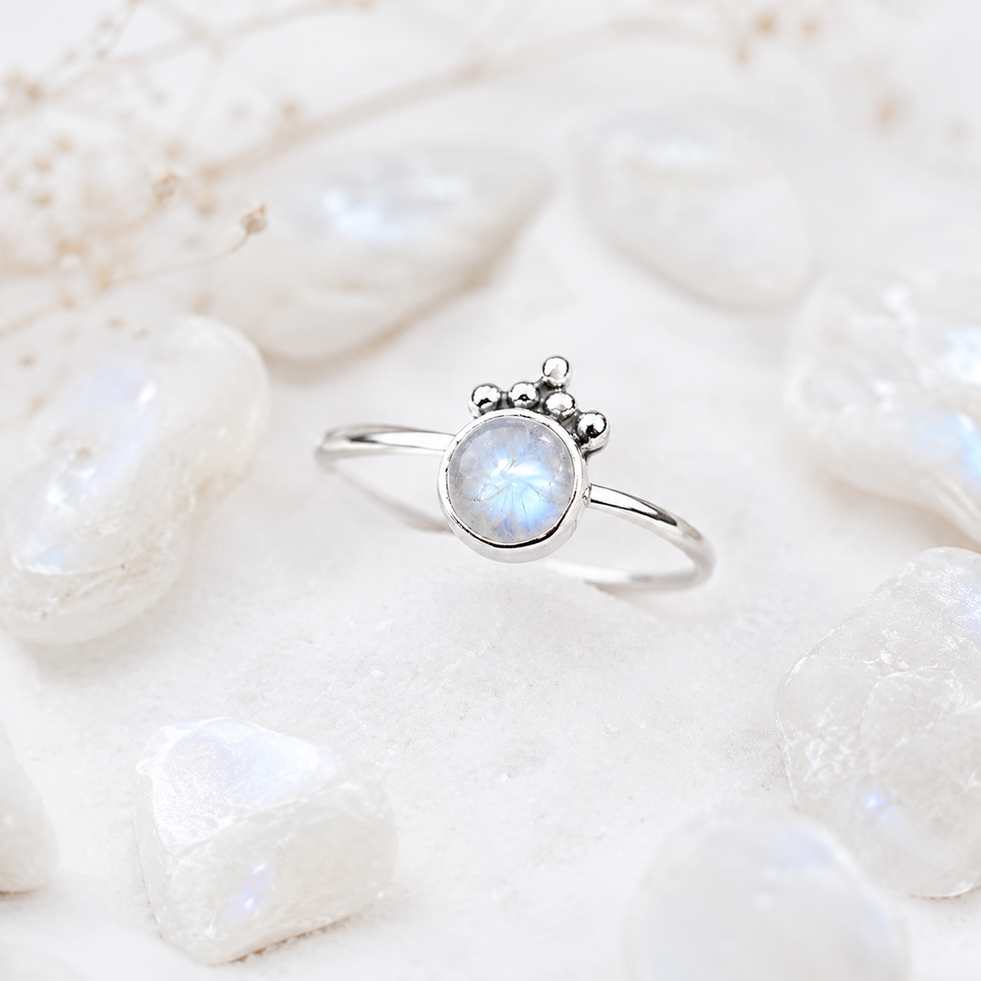 Silver ring with a moonstone on a light background