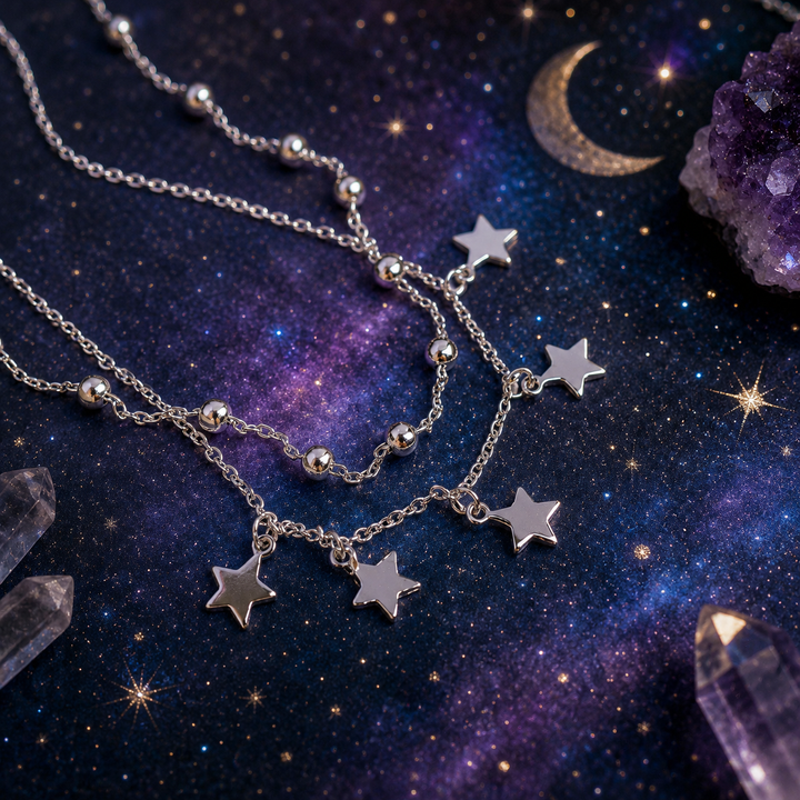 Silver star-shaped ANKLET on a cosmic background with crystals and a moon.
