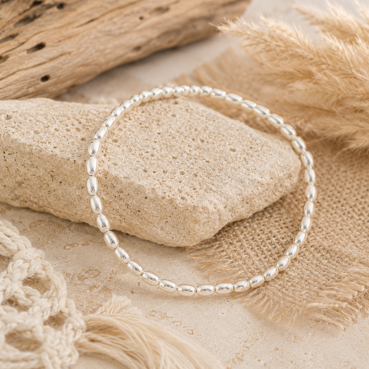 sterling silver bracelt wit seed sahper beads an elastic cord 