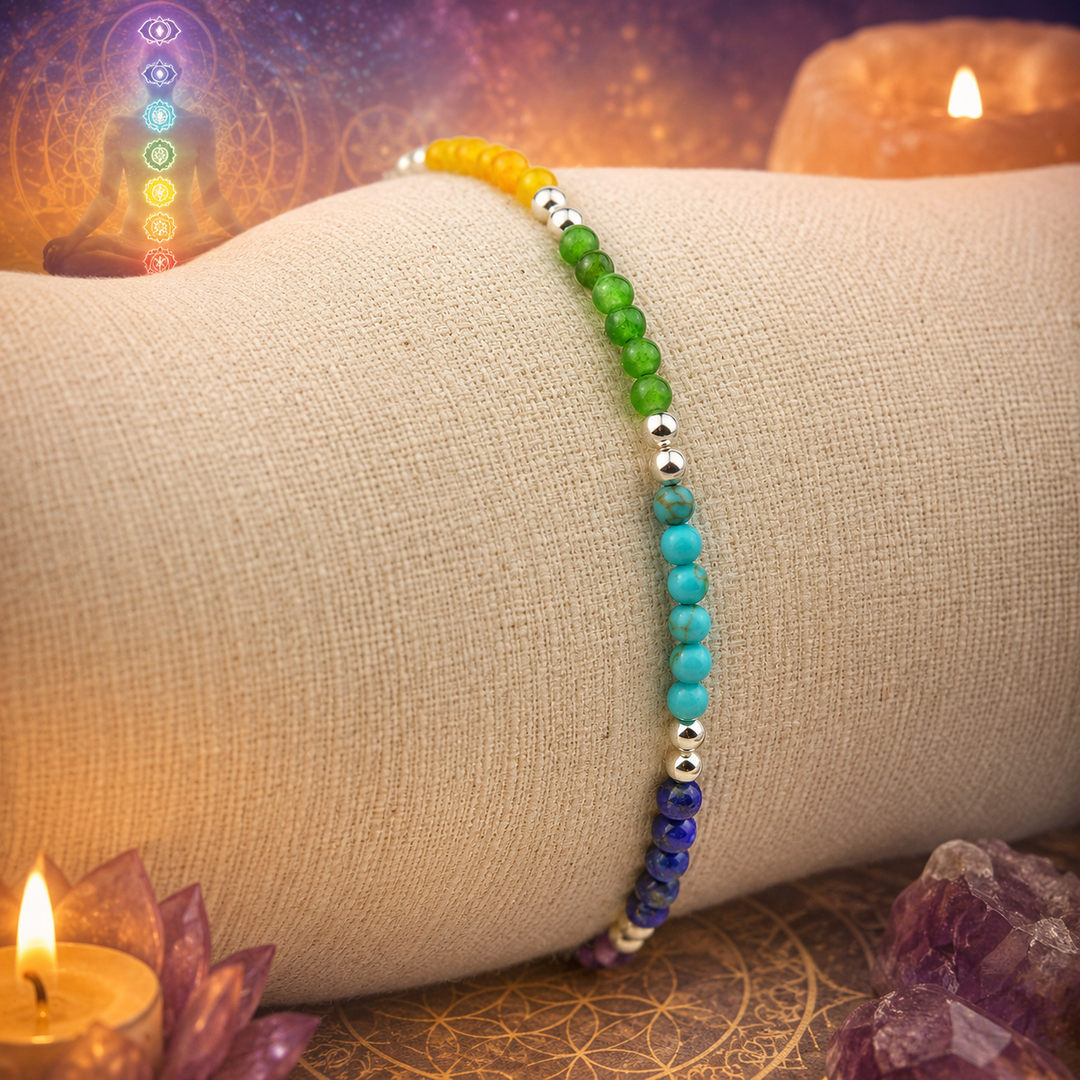 Colorful beaded bracelet on a person's wrist with candles and crystals in the background